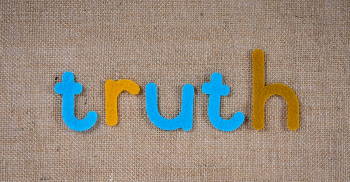 The word 'truth' in colorful felt letters on a burlap background.